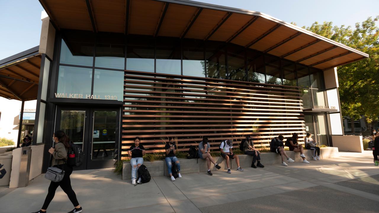 Students Sit on the promenade in Walker Hall