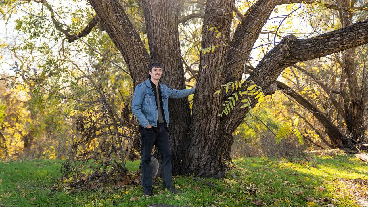 Pictured, Groh with a California black walnut tree on the UC Davis campus.