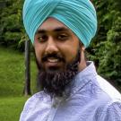 Rajul Bains smiles at the camera.