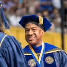 Photo of Chancellor May handing a degree to a student at Commencement 